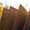 sheets of weathered corten steel lined up outside