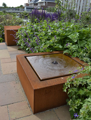 square water table in corten steel on garden patio