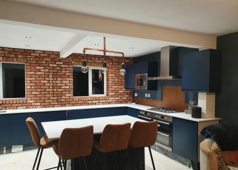 aged copper splashback in blue kitchen