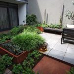 square Corten steel vegetable planter in modern courtyard garden space
