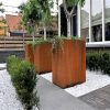 tall rectangular corten steel planters in a line